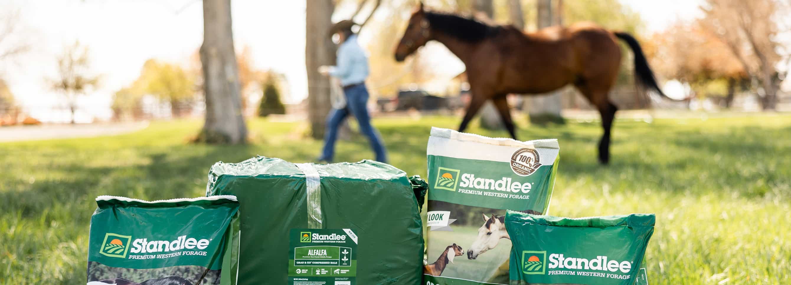 Standlee bagged forage products with horse in pasture.