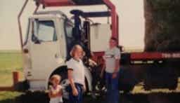 The Standlee family standing next to a truck