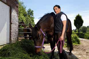 Woman Holding Horse