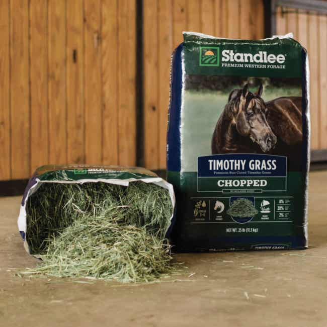 An opened bag of Chopped Timothy Grass next to an unopened bag
