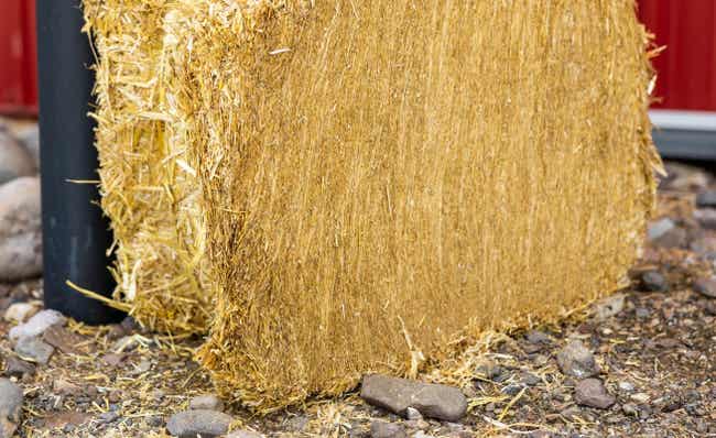 Hay bale in front of barn