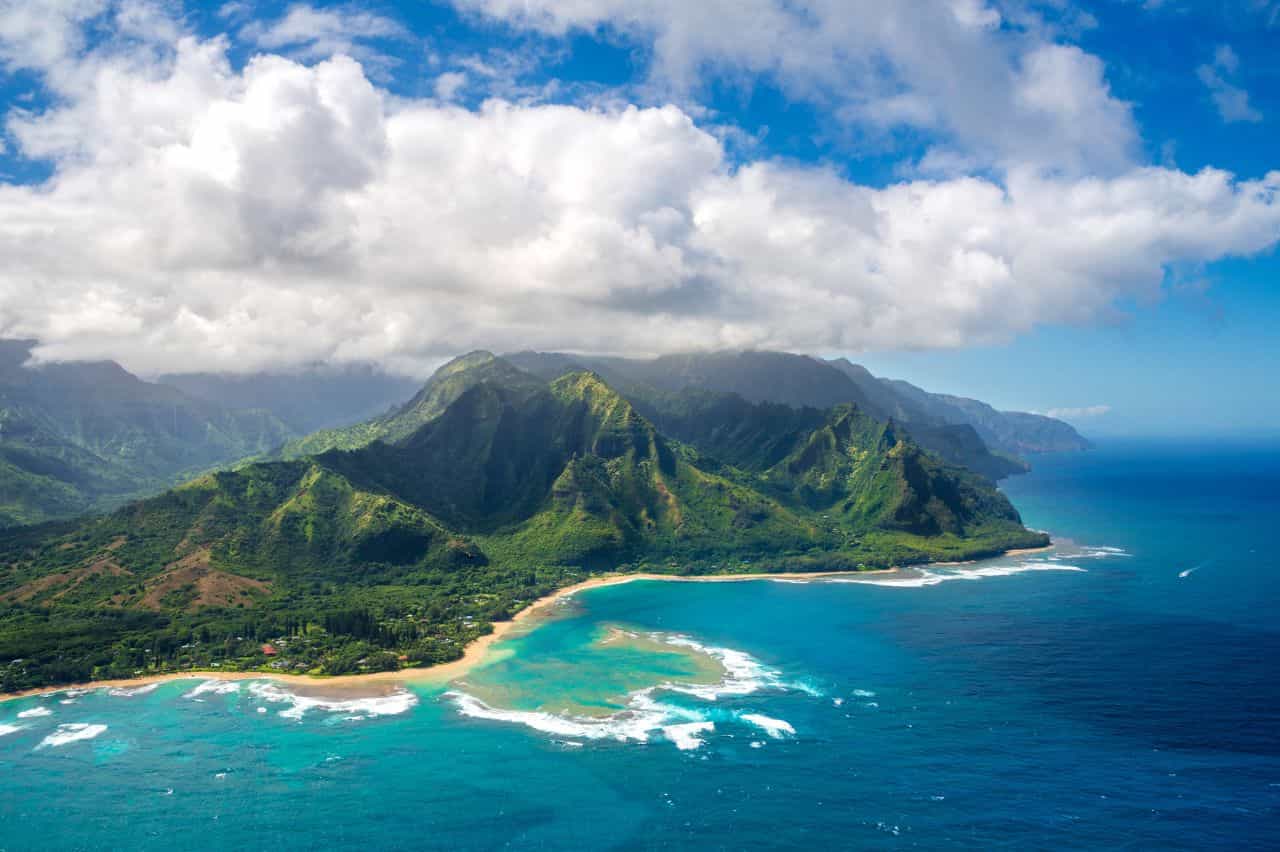 Island in blue water seen from a distance