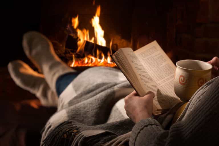 Reading book by a fire