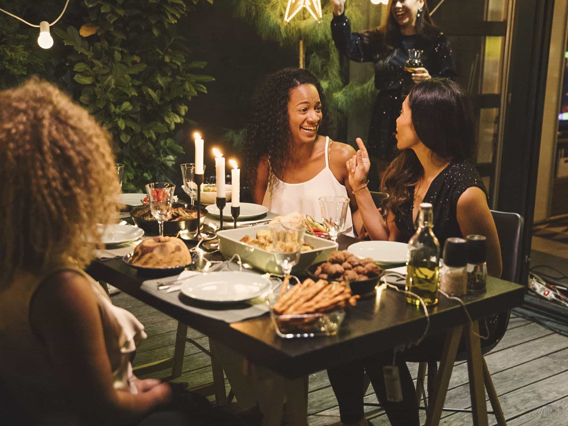 Friends talking around dinner table