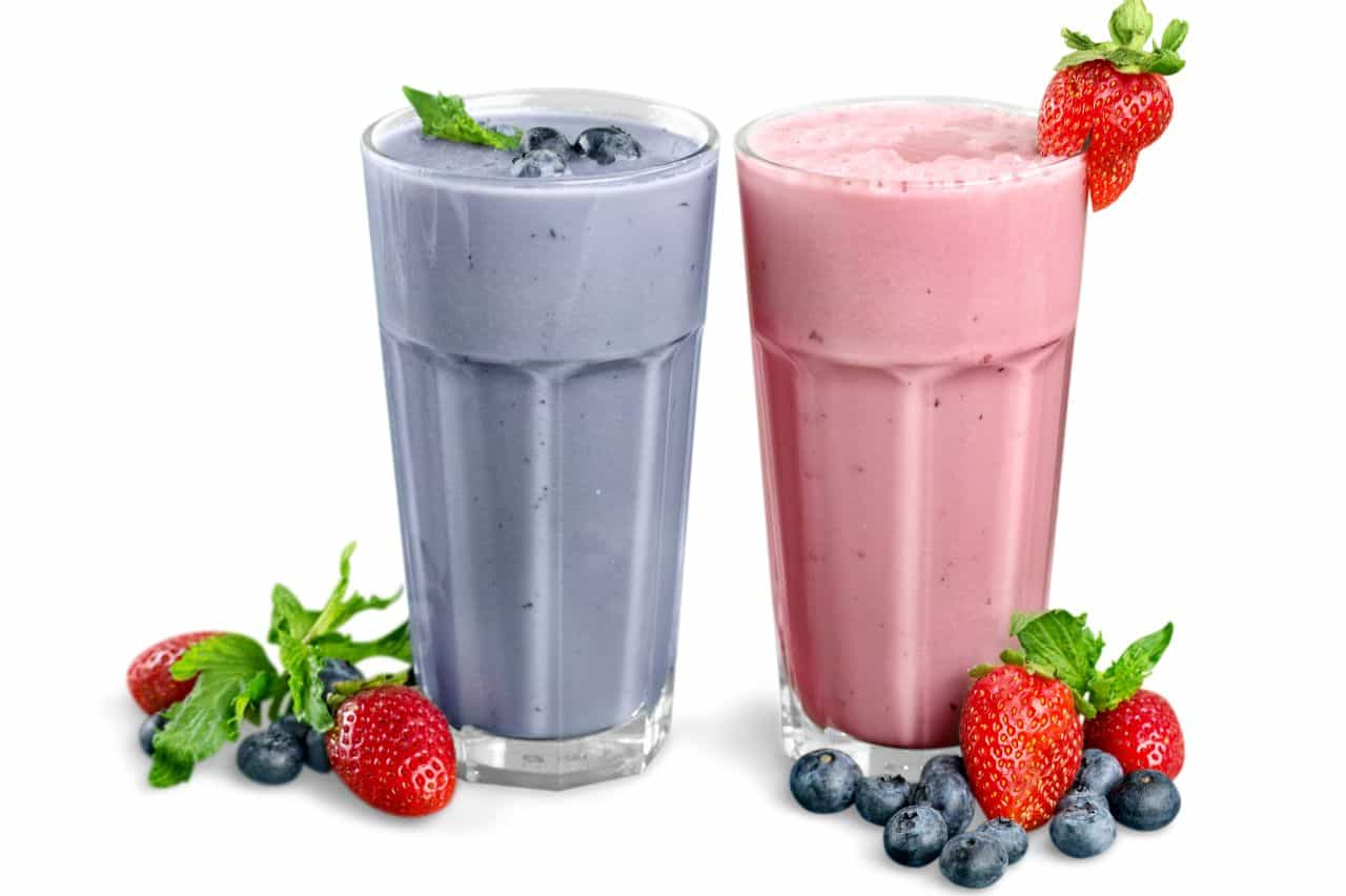 Blueberry and strawberry smoothies in glass cups