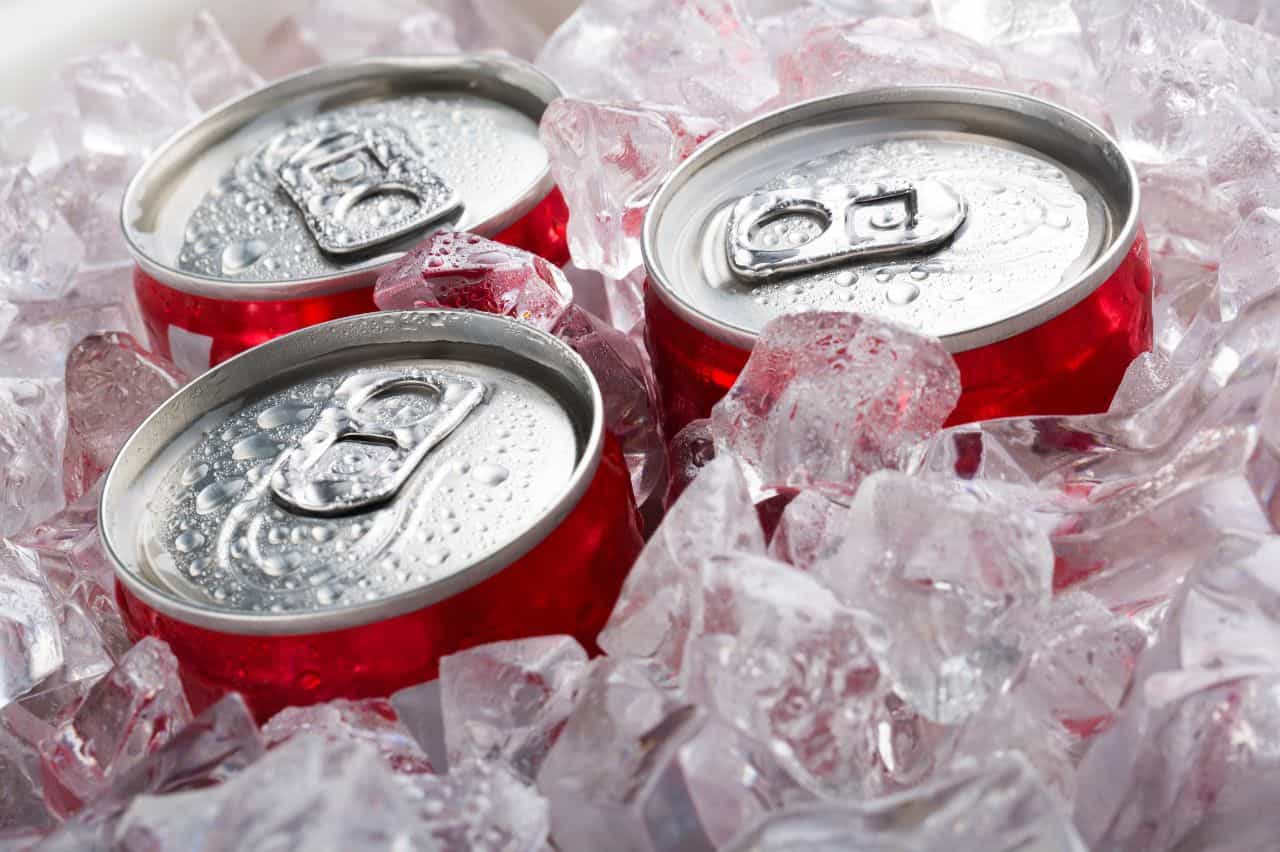 Red cans buried in ice with tops exposed
