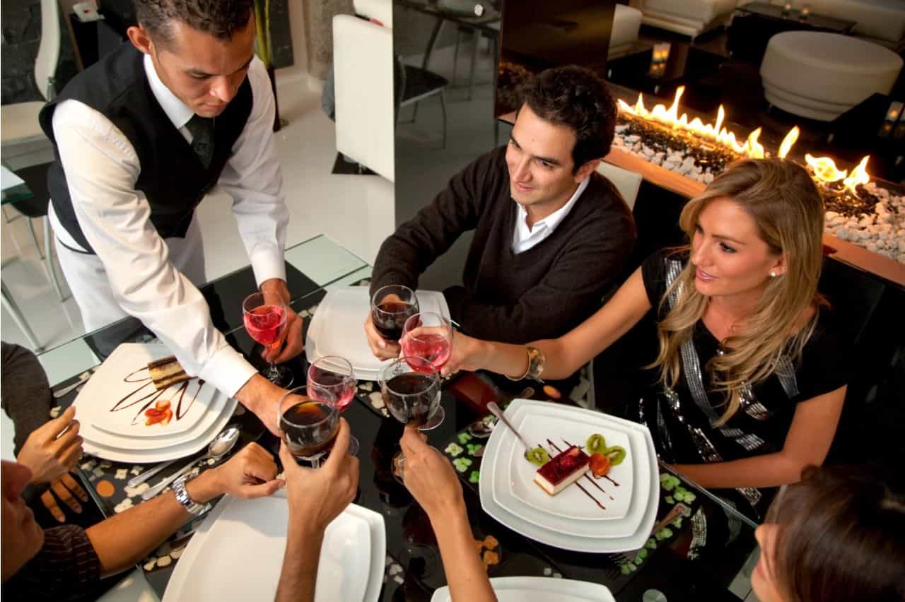 Waiter serving drinks to a table