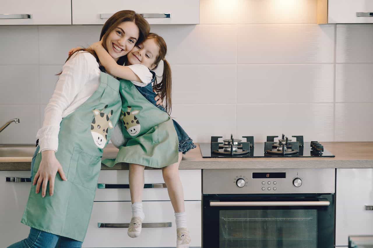 Mother and daughter smiling in the kitchen
