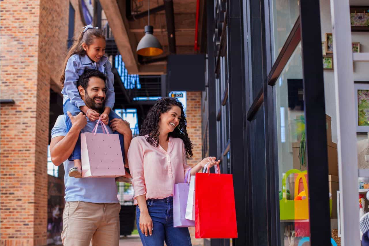 Dad with daughter on shoulders and mom out shopping